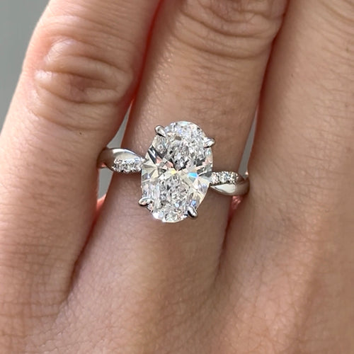Oval Cut Diamond Twisted Band with Round Brilliant Cut Diamonds Engagement Ring