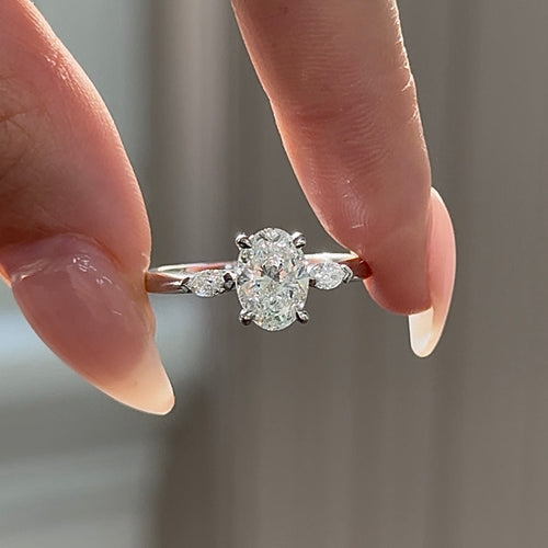 Oval Cut Diamond with Marquise Cut Side Diamonds Trilogy Engagement Ring